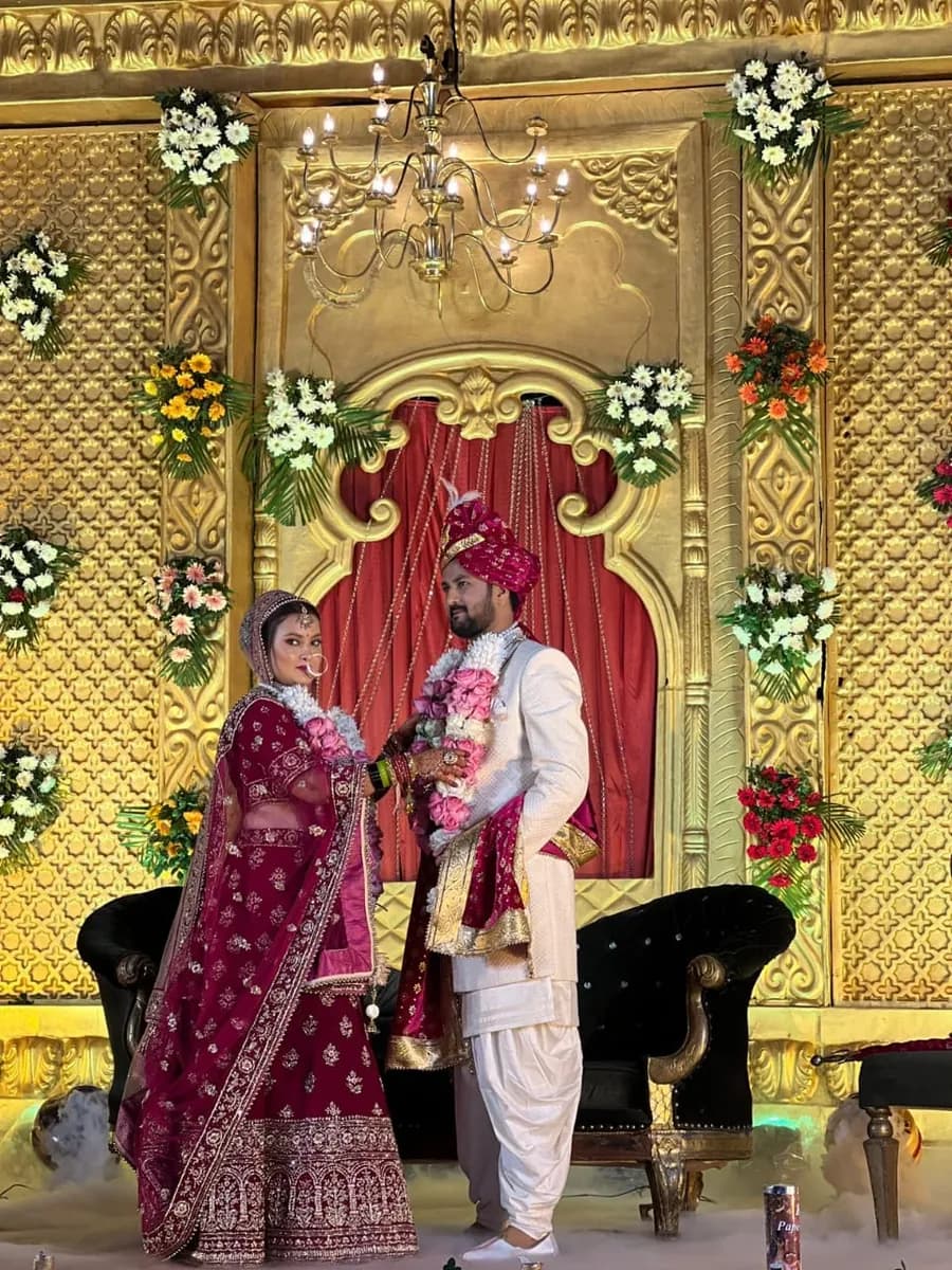 Indian bride and groom at a decorated wedding stage