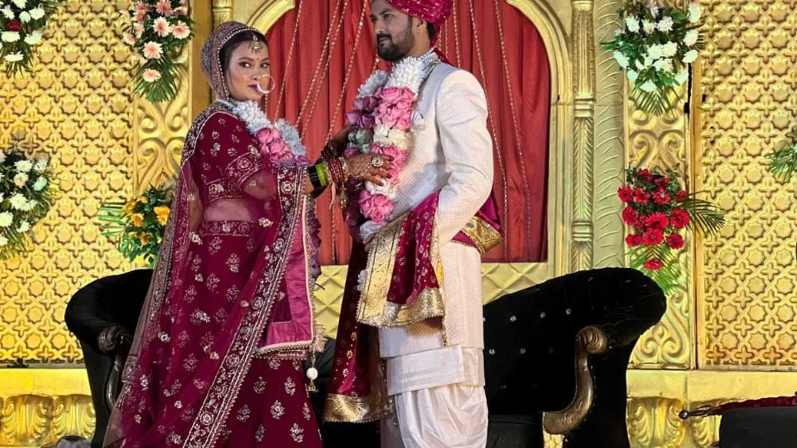Indian bride and groom at a decorated wedding stage